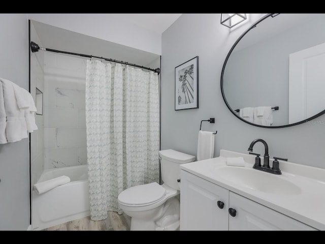 full bathroom featuring toilet, vanity, wood-type flooring, and shower / bathtub combination with curtain