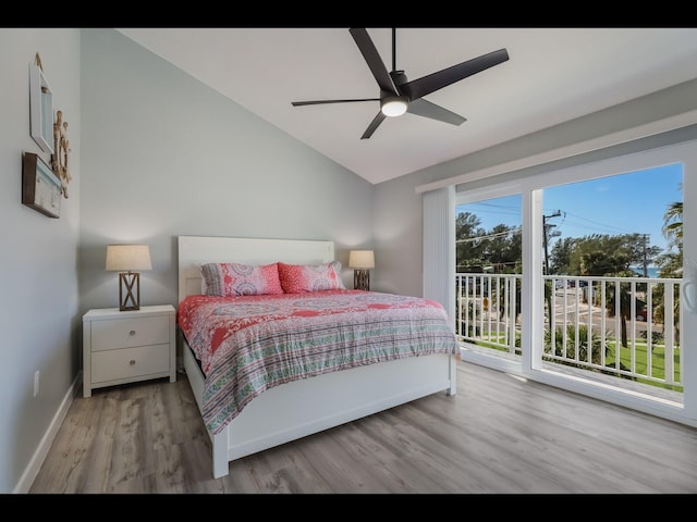 bedroom with light wood-type flooring, lofted ceiling, ceiling fan, and multiple windows