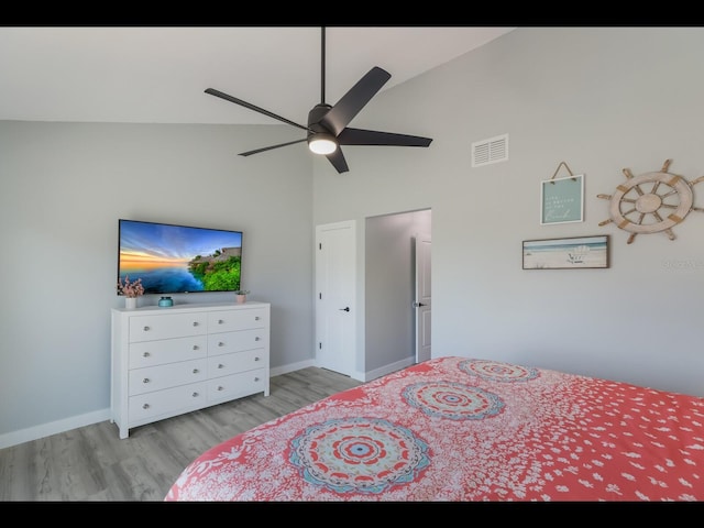 bedroom featuring ceiling fan, high vaulted ceiling, and light hardwood / wood-style flooring