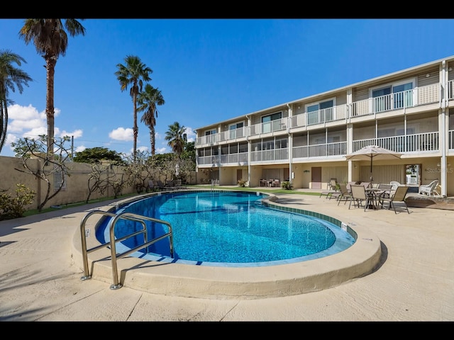 view of swimming pool with a patio area