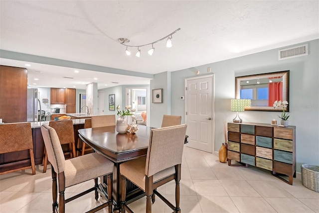 dining area with light tile patterned floors and sink