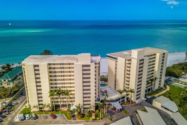 bird's eye view featuring a water view and a beach view