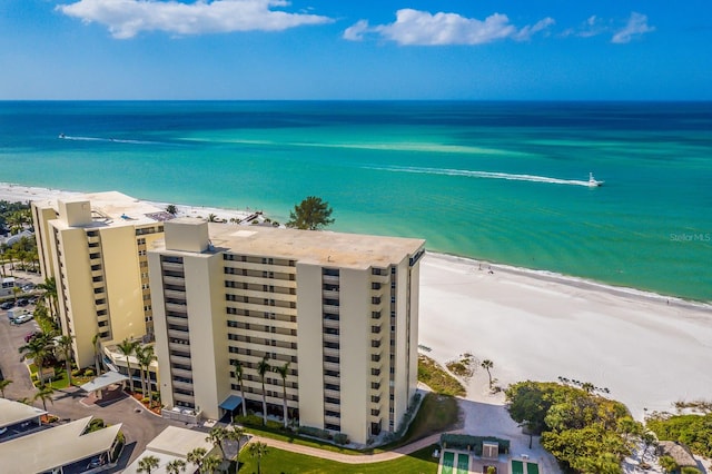 bird's eye view with a water view and a beach view