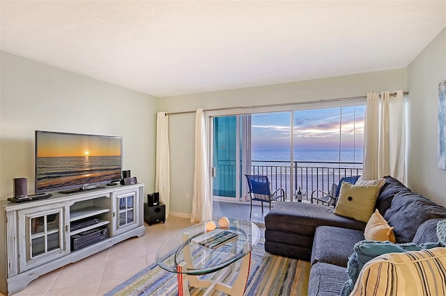 living room with a water view and light tile patterned floors