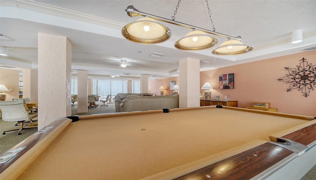 game room featuring a tray ceiling, ornamental molding, billiards, and ceiling fan