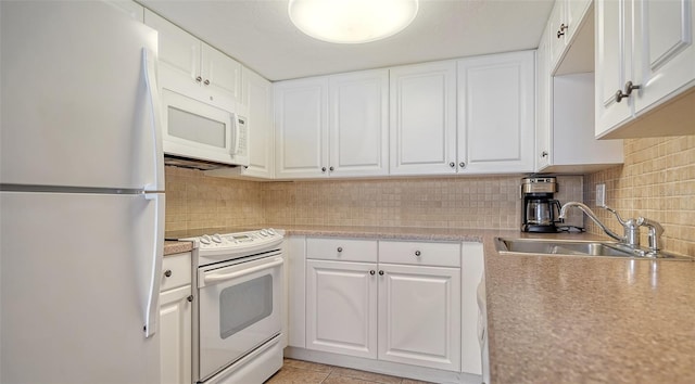 kitchen with white appliances, white cabinetry, sink, light tile patterned flooring, and tasteful backsplash