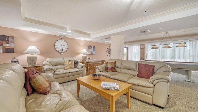 carpeted living room featuring a tray ceiling and crown molding