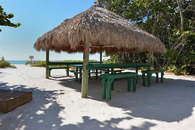 view of property's community with a water view and a gazebo