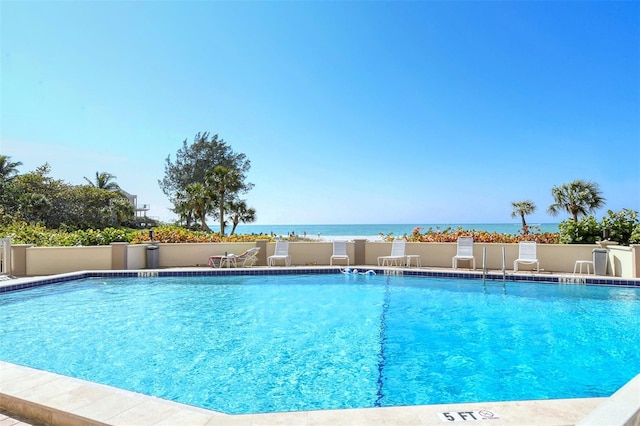 view of pool with a water view