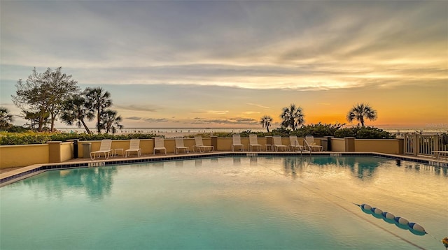 view of pool at dusk