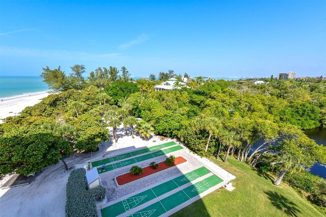 drone / aerial view featuring a water view and a view of the beach