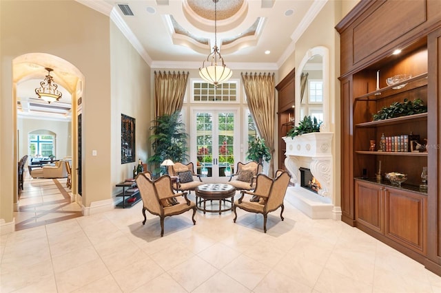 living area with plenty of natural light, french doors, light tile patterned floors, and ornamental molding