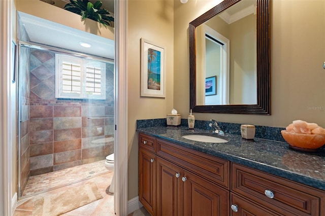 bathroom featuring ornamental molding, tile patterned floors, vanity, toilet, and walk in shower