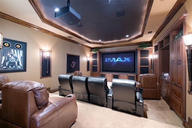 home theater featuring visible vents, a tray ceiling, ornamental molding, and light colored carpet