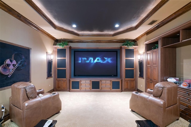 carpeted cinema with a raised ceiling and ornamental molding