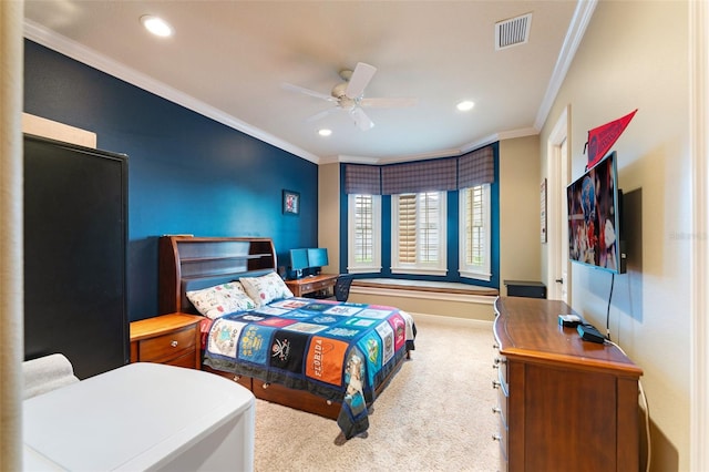 carpeted bedroom featuring ceiling fan and ornamental molding