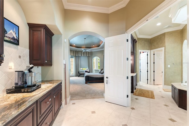 bathroom featuring tile patterned floors, vanity, and tasteful backsplash