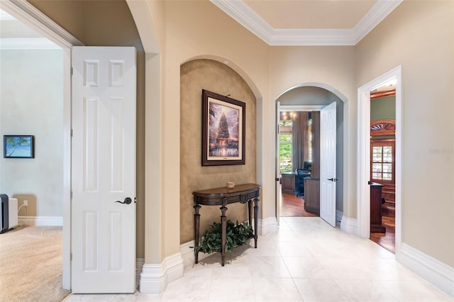 hall featuring light tile patterned floors and ornamental molding