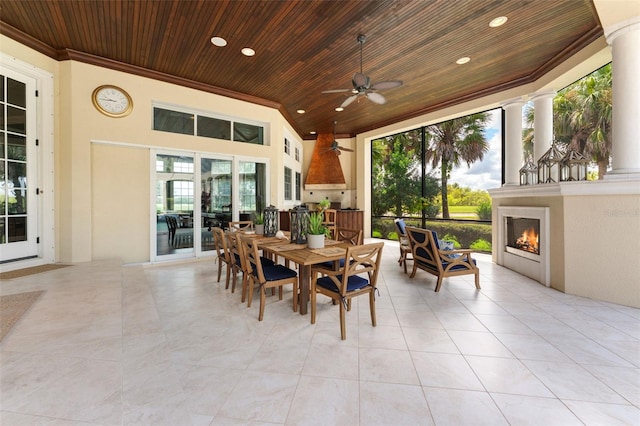 exterior space featuring ceiling fan and a fireplace