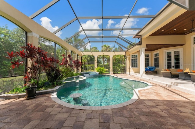 view of pool featuring glass enclosure, an in ground hot tub, an outdoor living space, ceiling fan, and a patio