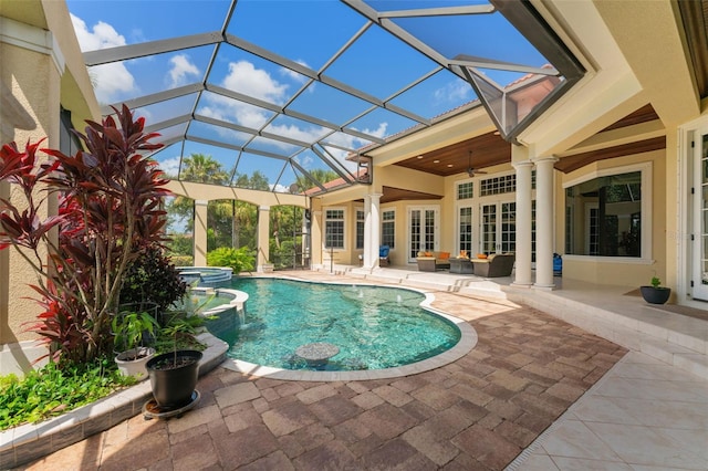 view of swimming pool with ceiling fan, glass enclosure, and a patio area