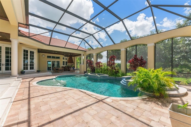 view of pool with an in ground hot tub, ceiling fan, a patio area, and a lanai