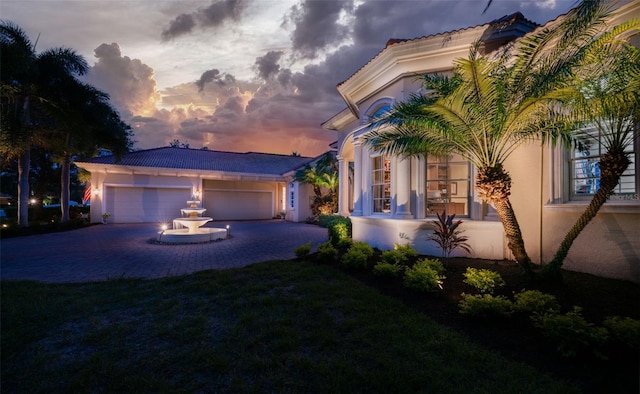 view of front of home featuring a lawn and a garage