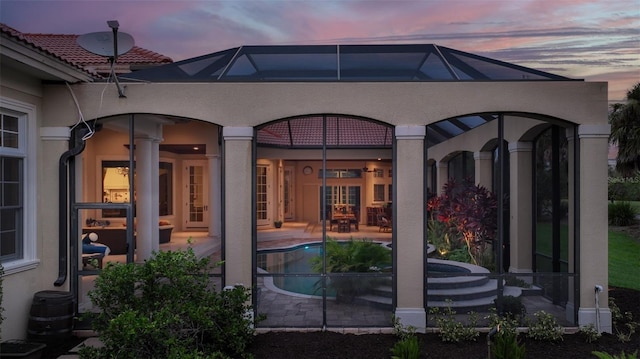 back house at dusk with a patio