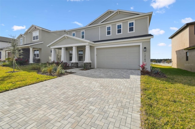 view of front of house featuring a garage and a front lawn