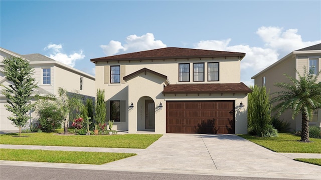 mediterranean / spanish home with a front lawn, driveway, an attached garage, and stucco siding