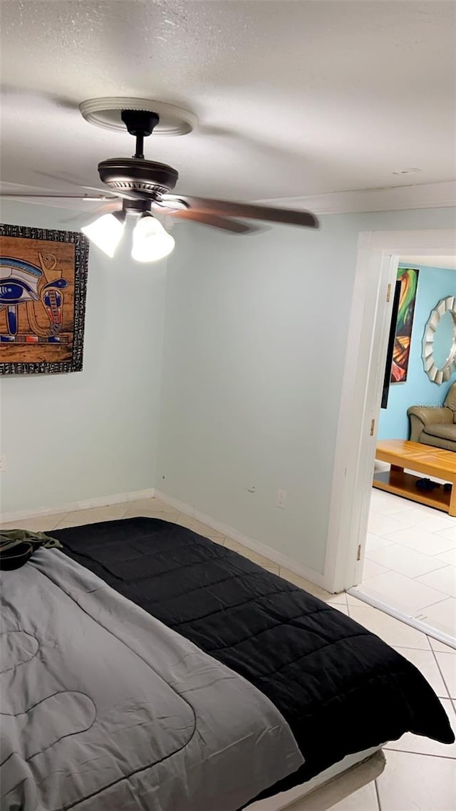 tiled bedroom featuring a textured ceiling and ceiling fan