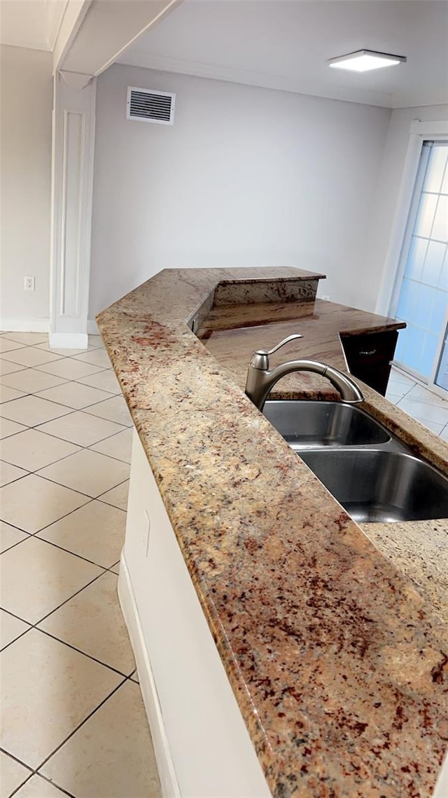 kitchen featuring light tile patterned flooring and sink