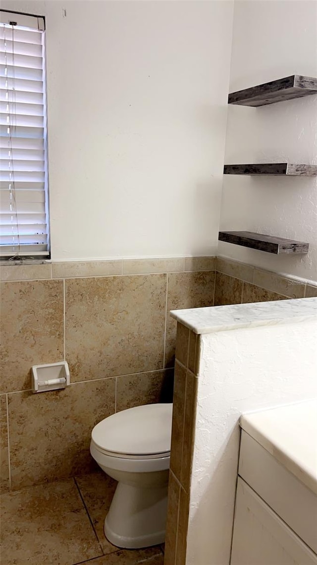 bathroom featuring tile patterned floors, vanity, and toilet