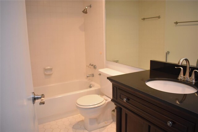 full bathroom with tile patterned flooring, toilet,  shower combination, and vanity