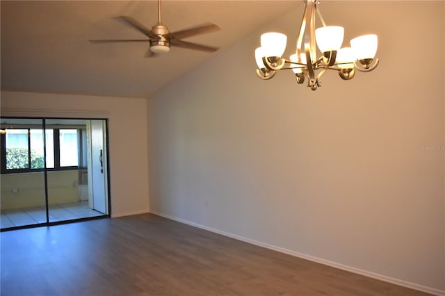 spare room featuring ceiling fan with notable chandelier, vaulted ceiling, and wood-type flooring