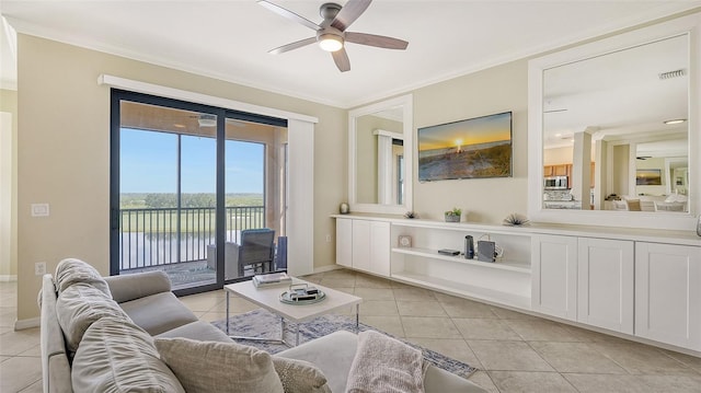 living room featuring ceiling fan, light tile patterned floors, and crown molding