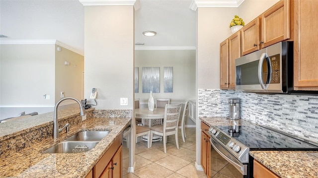 kitchen with appliances with stainless steel finishes, light stone counters, crown molding, and sink