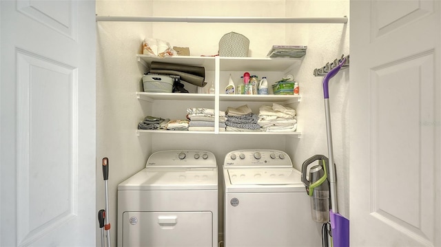 clothes washing area with washing machine and dryer