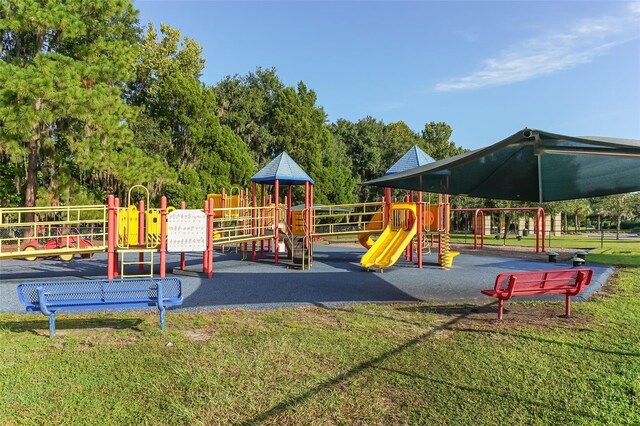 view of playground with a lawn