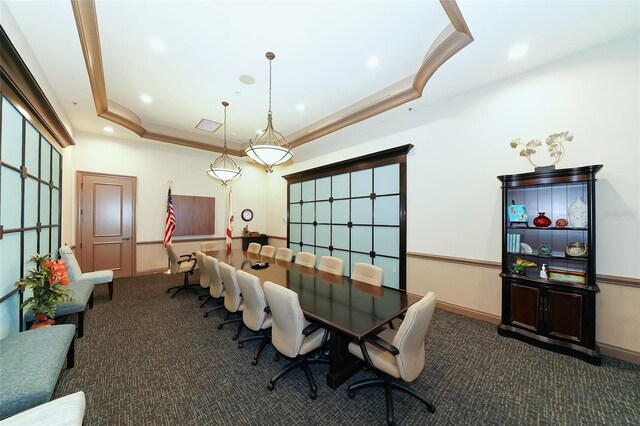 carpeted dining room featuring a raised ceiling