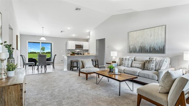 living room featuring lofted ceiling