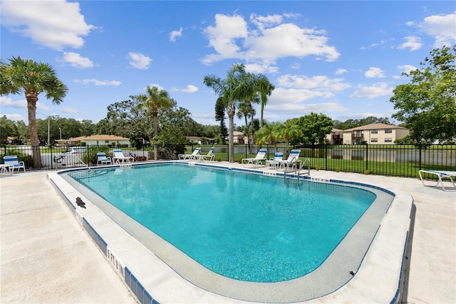 pool featuring a patio and fence