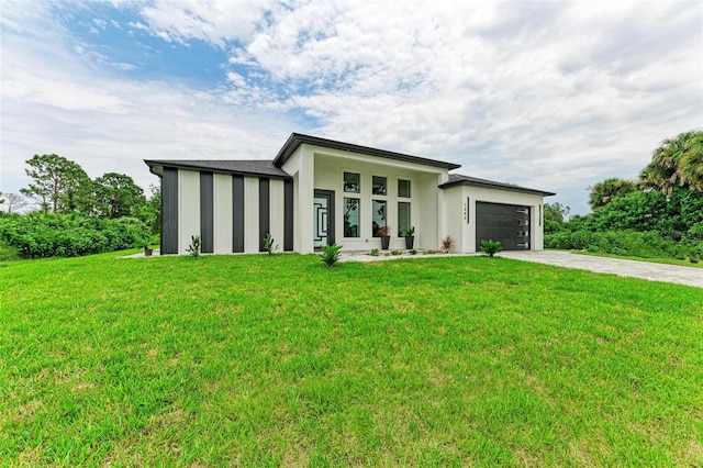 view of front of property featuring a garage and a front yard