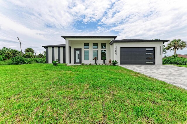 view of front of property with a garage and a front yard