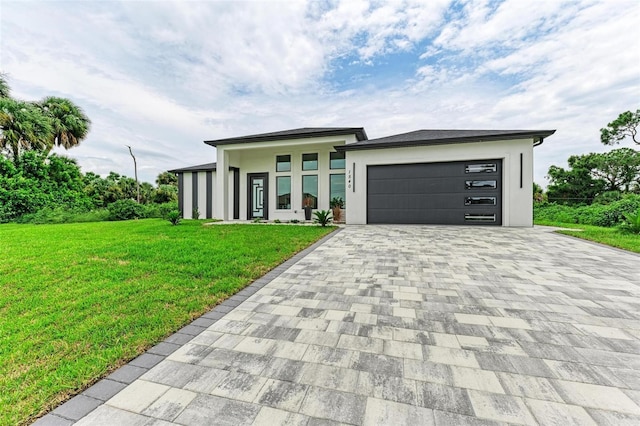 view of front of house with a garage and a front yard