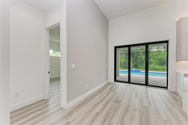 unfurnished room with light wood-type flooring