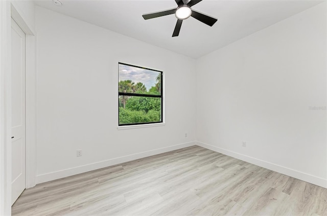 spare room featuring ceiling fan and light hardwood / wood-style flooring