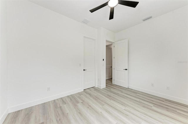 empty room with ceiling fan and light hardwood / wood-style floors