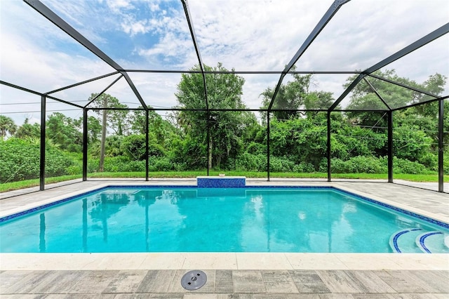 view of pool featuring a patio area and glass enclosure