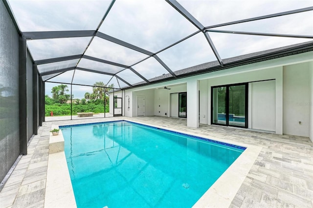 view of pool with a patio, a lanai, and ceiling fan